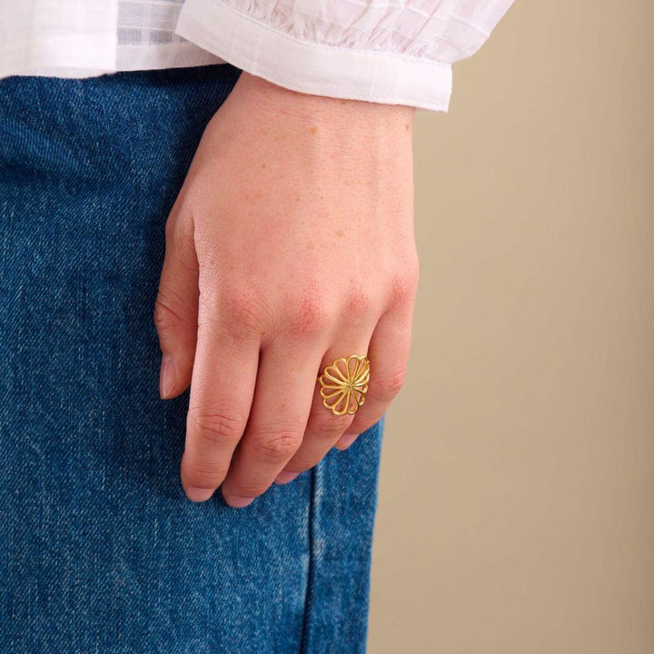 Pernille Corydon Large Bellis Gilded Ring worn on one hand, floral motif in gold, Model R-328-GP-002-2