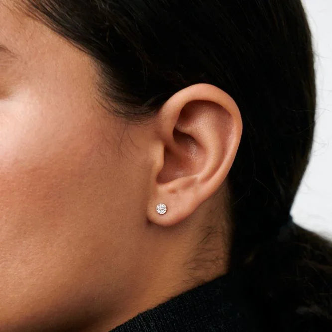 Pernille Corydon Mini Nature ear studs in silver appear discreetly in the ear of a woman. Model E-391-S-2