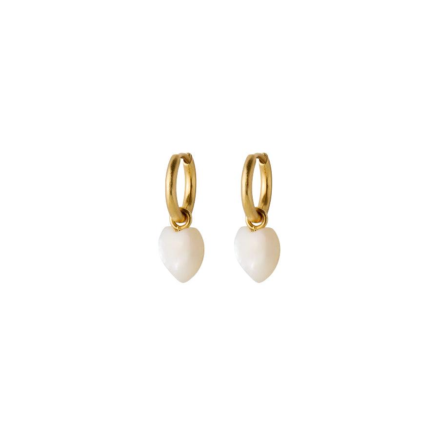 Pernille Corydon Ocean Heart gold-plated huggies with white heart-shaped pendants on a white background. Model E-387-GP-1.
