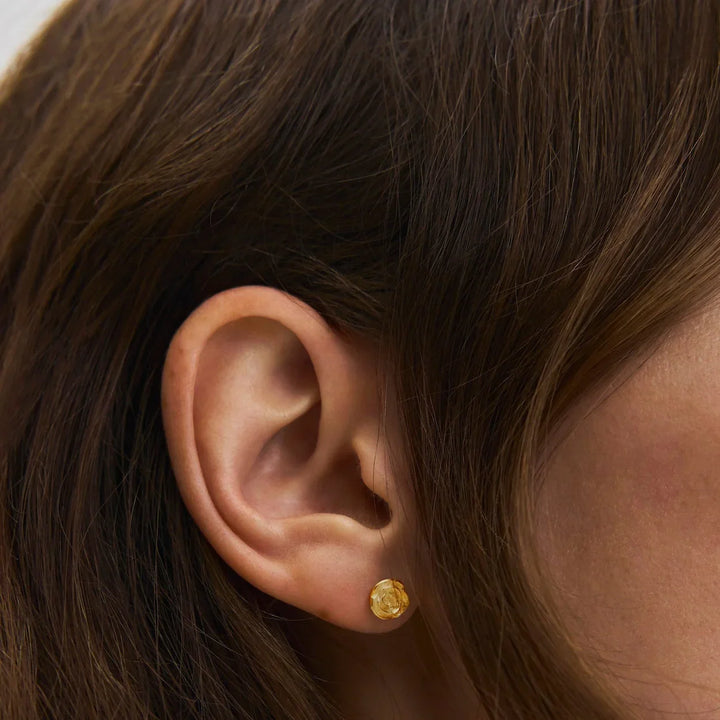 Pernille Corydon Small Rose gold-plated stud earrings appear on ear, elegant flower shape. Model E-535-GP-2