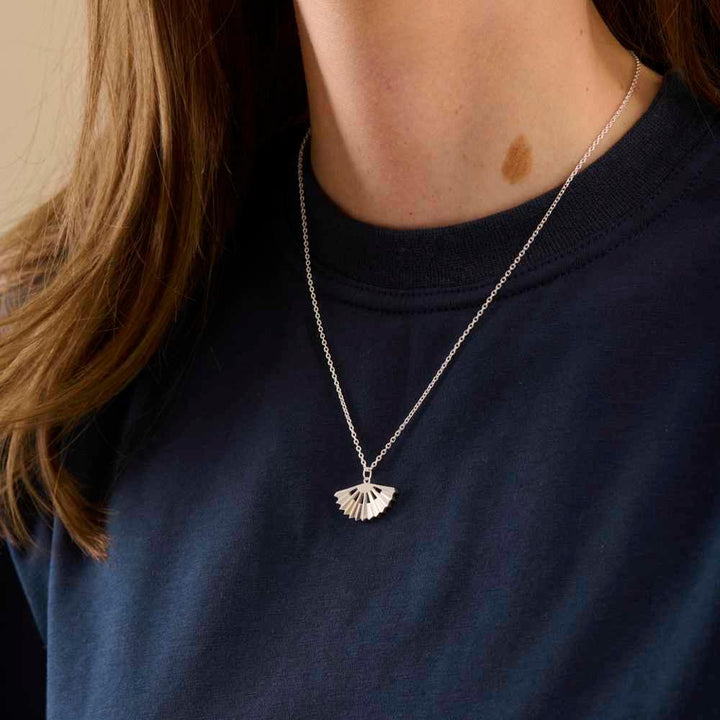 Pernille Corydon Sphere necklace in silver with unique pendant, worn by a woman. Model N-495-S.