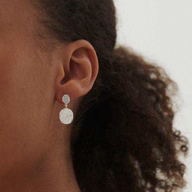 Pernille Corydon Storm silver earrings shown on ear, matte hammered surface. Model E-048-S-1