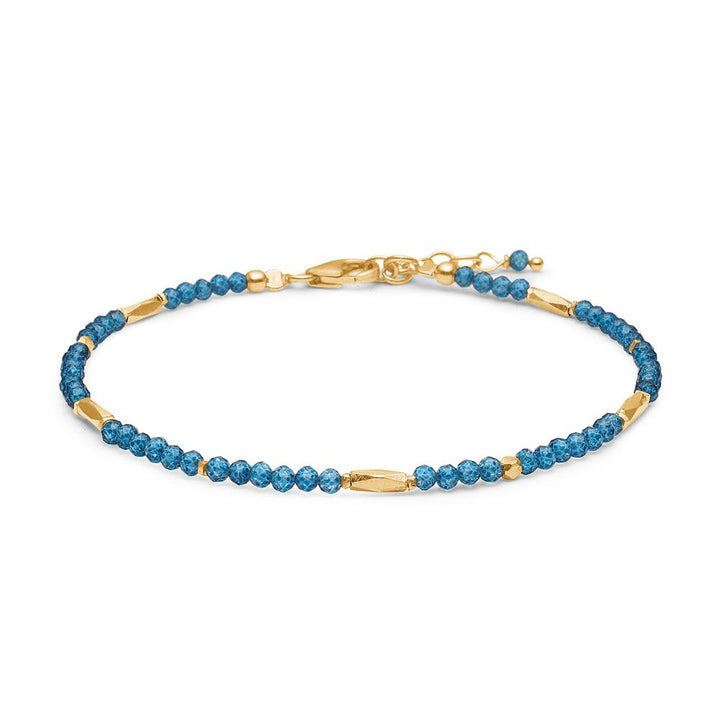studio-z-evergreen-bracelet-with-london-blue-topaz shown as delicate bracelet with blue gemstones and gold details. Model 8256851