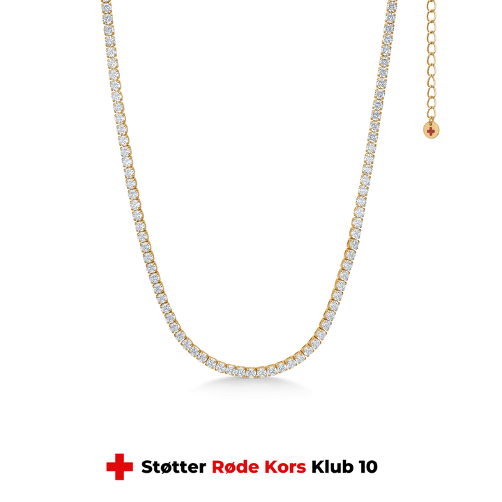 studio-z-tennis-necklace-in-gold-plated-sol-30-36cm-7227000, elegant tennis chain in gold-plated silver with clear stones on a green background. Model 7227000