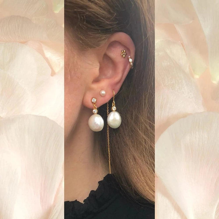 The Earring Shop Isla Hook Threader shown on ear with golden details and large white pearls, Model fw2303-2.