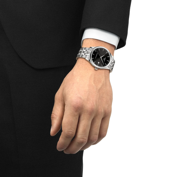 Tissot Classic Dream 40mm black dial on wrist, elegant watch with steel chain. Model T1584071105100