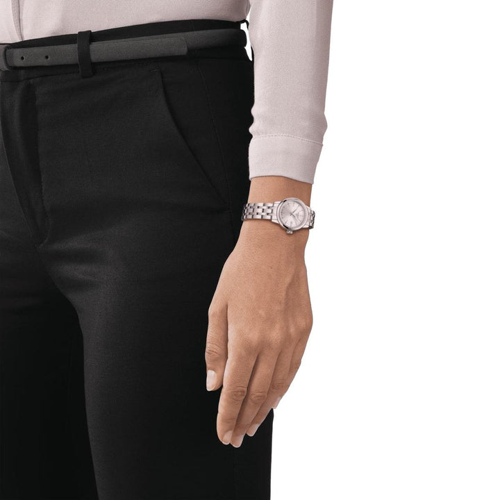 Tissot Classic Dream Lady with silver dial on women's wrist, elegant steel chain. Model T1292101103100