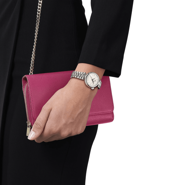 Tissot Desir 28mm mother-of-pearl dial and diamonds displayed on the wrist, silver watch strap, elegant look. Model T1520101111600