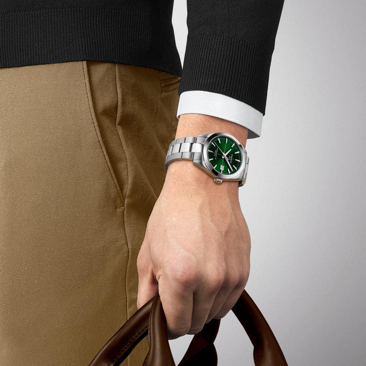 Tissot Gentleman Powermatic 80 Silicon with green dial and steel chain is worn on men's hands. Model T1274071109101