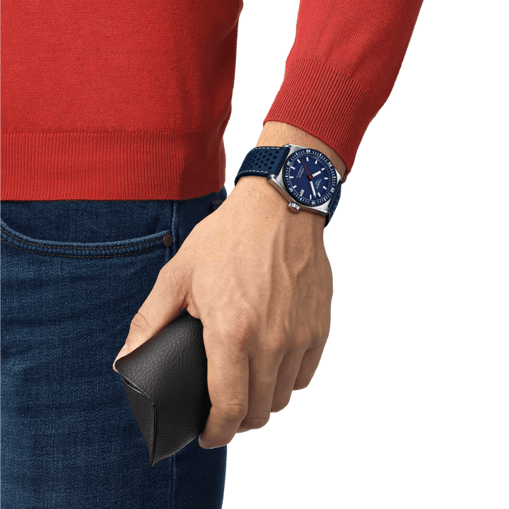 Tissot PR516 Powermatic 80 with blue dial and perforated blue strap on wrist, Model T1494071604100.