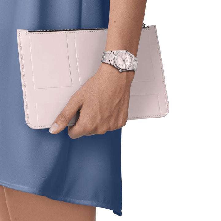 Tissot PRX 35mm dial with white mother-of-pearl, silver bracelet, worn on a woman's hand. Model T1372101111100