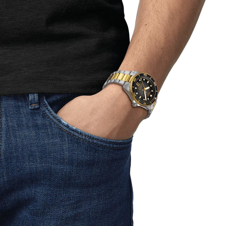 Tissot Seastar 1000 Powermatic 80 black dial with gold PVD on wrist, two-tone chain. Model T1208072205100