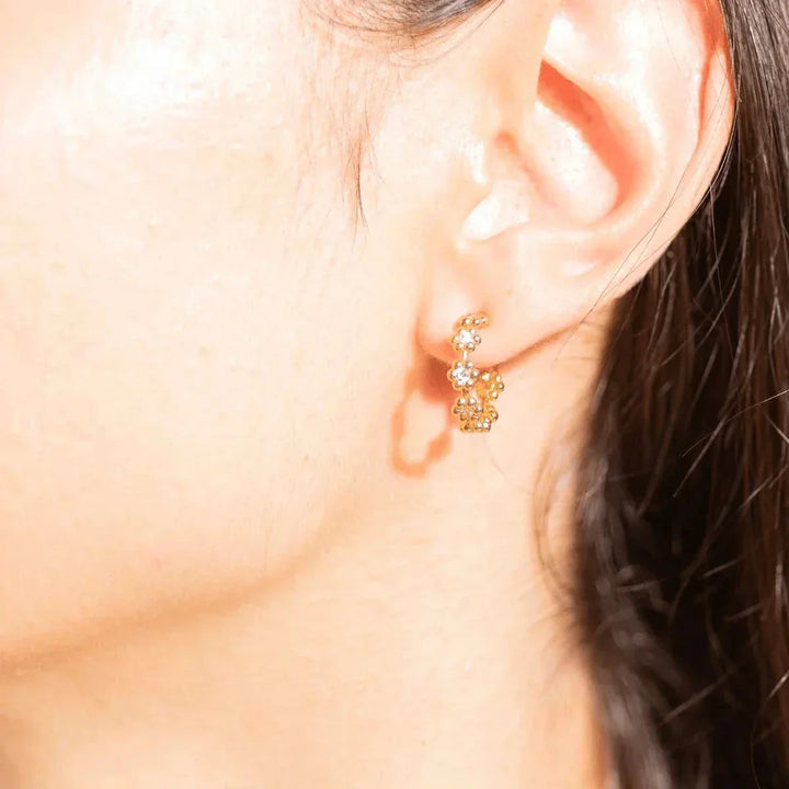 Vincent Bloom Hoops Earrings gold-plated with white crystals worn in the ear, elegant design. Model VJ244-UEG-2