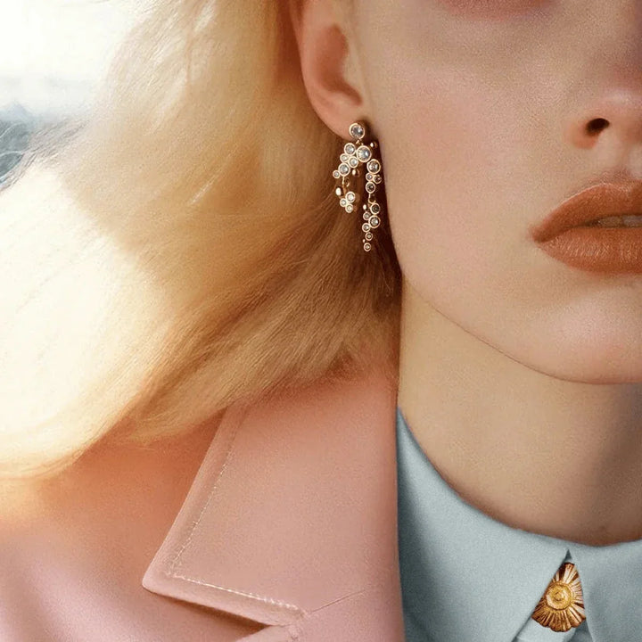 Vincent Lost Ember Gold Plated Earrings shown on model with blonde hair, elegant design with pearl details. Model VJ156-UEG-2