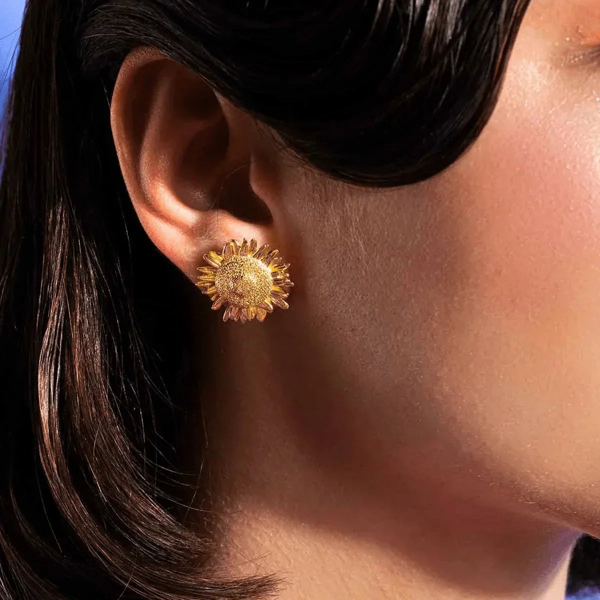 Vincent Mock Meadow Sunflower Earrings Gold plated shown on ear, detailed sunflower design in gold. Model VJ130-UEG-1
