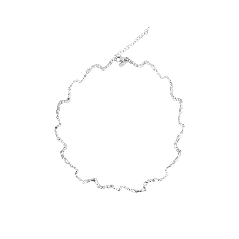 Vincent Nightfall Silver Necklace shown on white background with wavy, shiny silver structure. Model VJ127