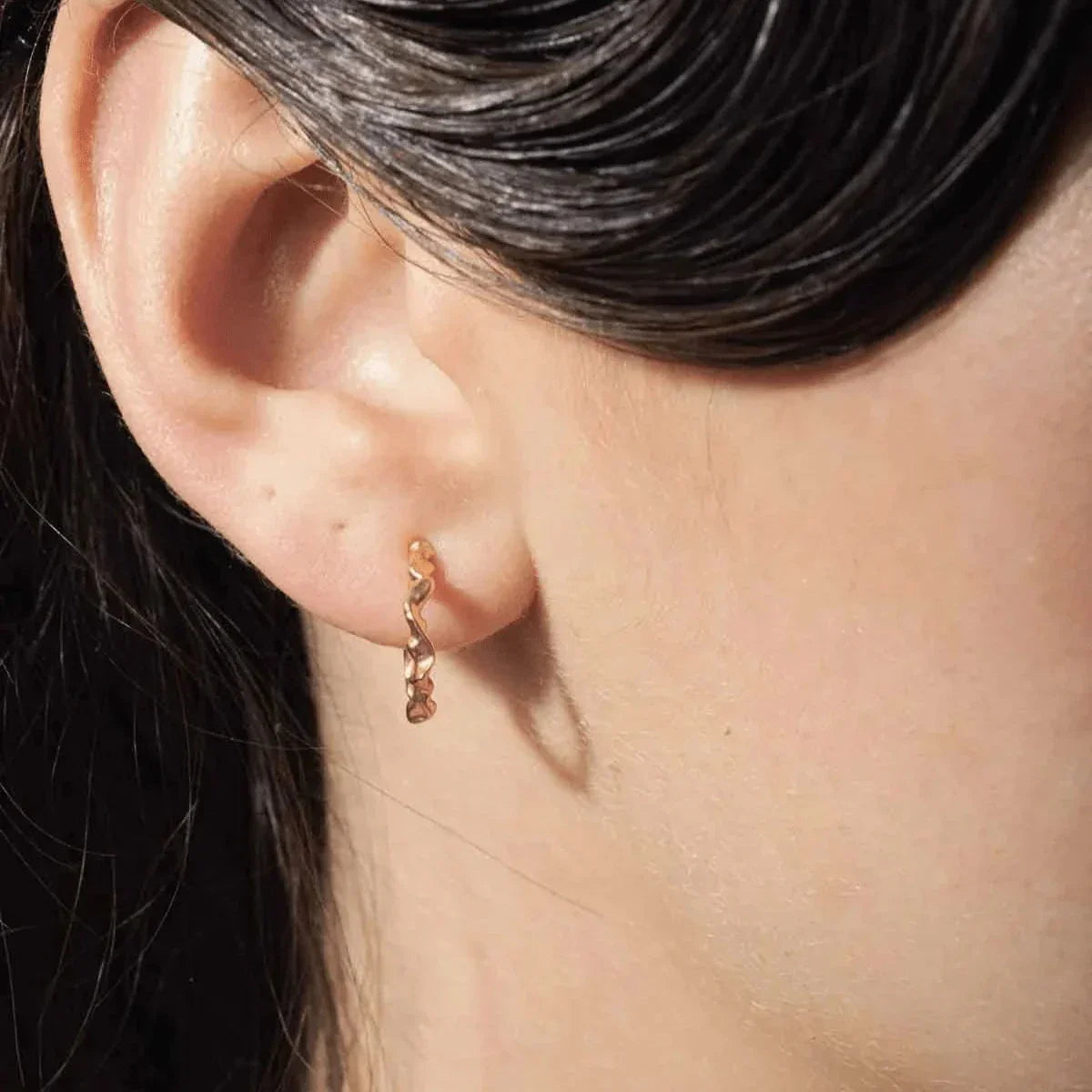 Vincent Shaman Gold Plated Hoops Earrings Small 14mm shown on ear, shiny golden surface. Model VJ126-UEG-S-1