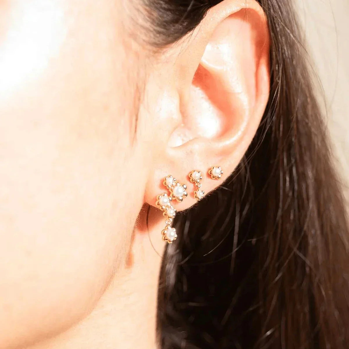 Vincent Venus Bloom Earrings Gold Plated Set of 3 Earrings shows three fine gold plated earrings with white stones on ear. Model VJ246-UEG