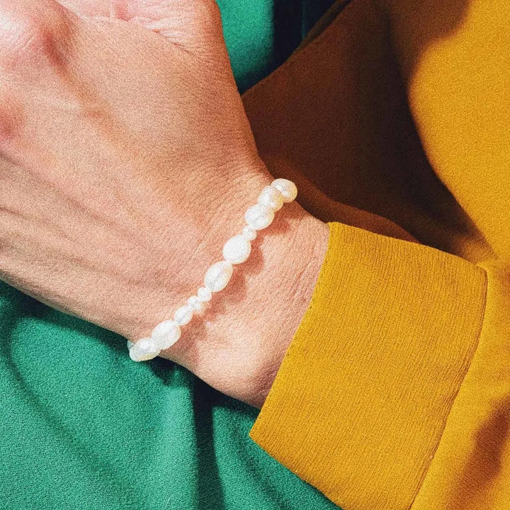 Vincent Venus Conspiracy Gold Plated Pearl Bracelet shows an elegant pearl bracelet on wrist, Model VJ087-UBG-1.