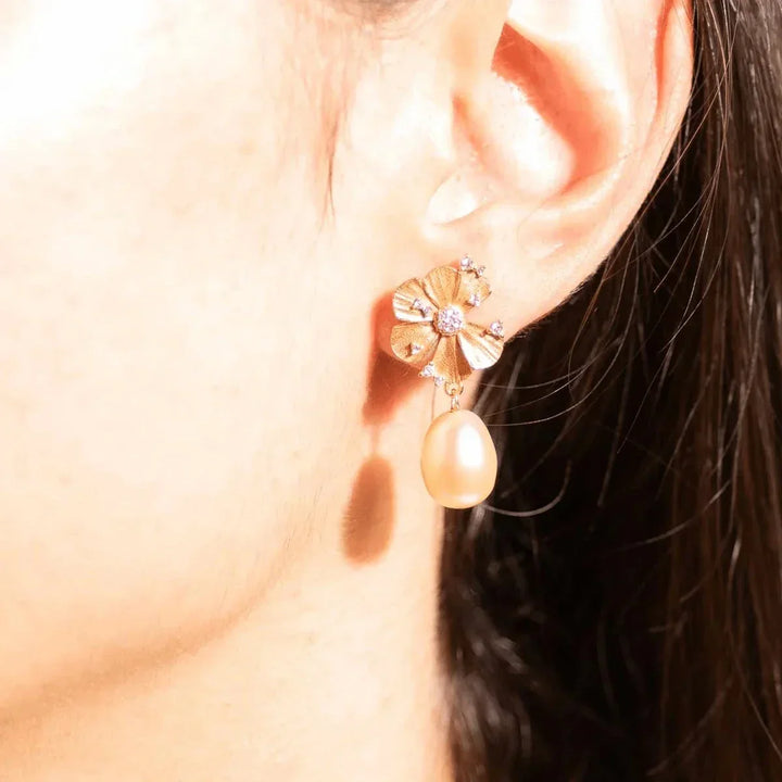 Vincent Venus Wildflower Earrings pink pearl gold plated show on ear, flower motif and drop shaped pearl. Model VJ247-UEG-2