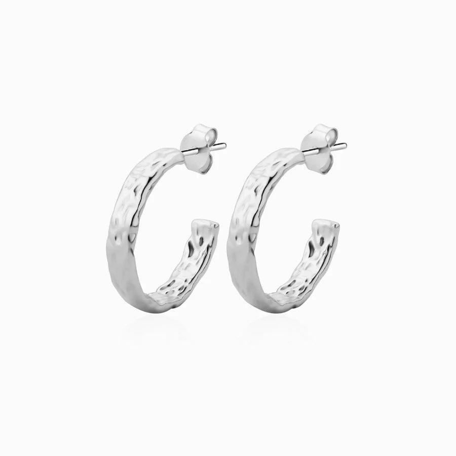 Wioga Hella Hoop in silver showcases a pair of rustic, textured hoops in polished sterling silver. Model 8711-s-1