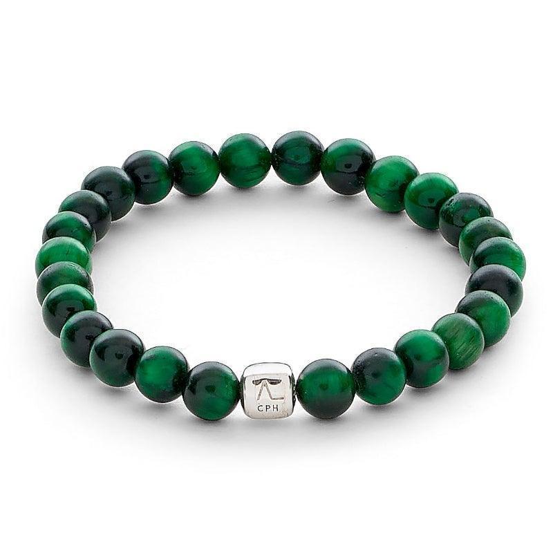 Alexander Lynggaard Armband Green Tiger Eye 6mm shows an elastic bracelet with green tiger eye beads and a silver colored detail. Model c00353-001-1
