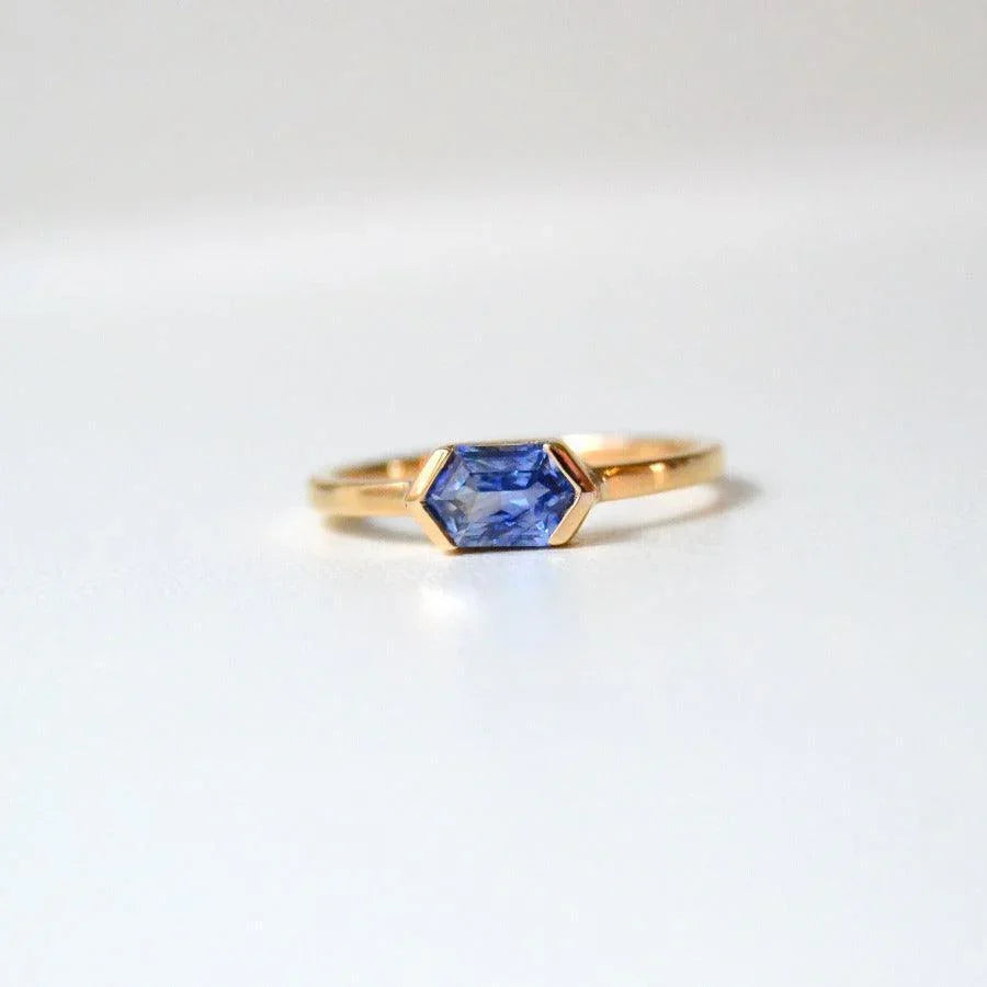 Anpe Atelier Customized Ring with blue sapphire shown close up, elegant in gold with hexagonal blue sapphire stone. Model 27-blasafir-001-1