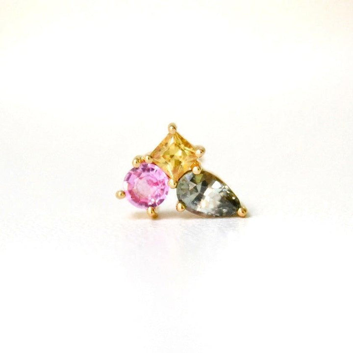 anpe atelier unika varnaya stud with sapphire 23 shows a unique stud in gold with pink, yellow and blue stones. Model23