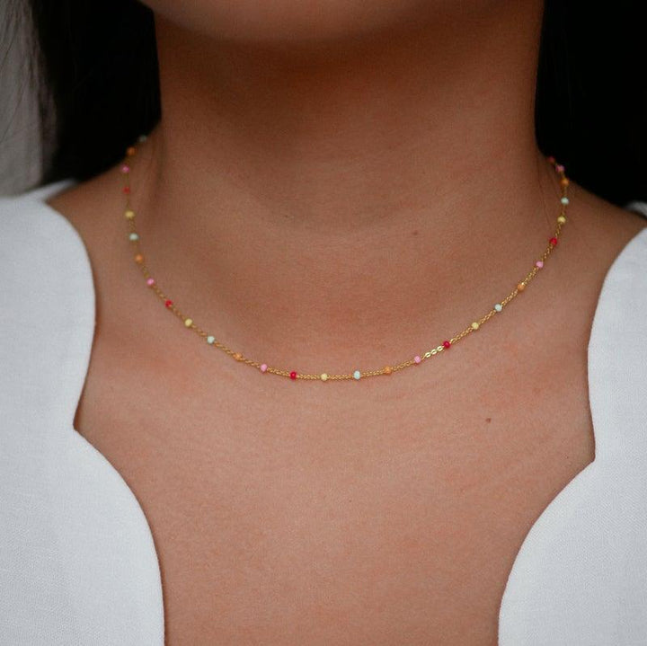 Enamel Lola Gilded Necklace N55G Rainbow, fine chain with small colored pearls on the model. Model N55G-RAINBOW