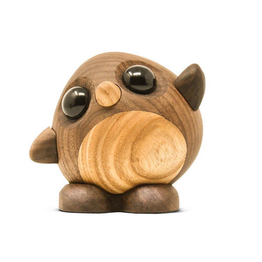 Fablewood Daisy the penguin stands on a white background, carved in light and dark wood with black eyes. Model 1104-1