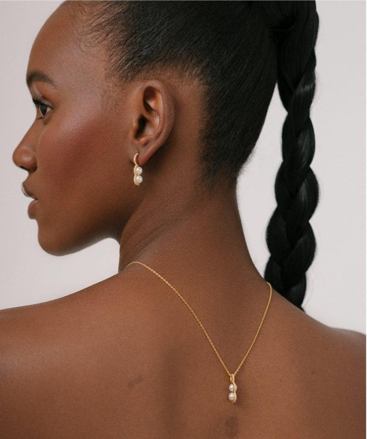 Herieth Paul x Polar Jewelry Bahati necklace worn by model, elegant gold with pearls. Model BAH-NL-GD-WP-WZ-00503-2