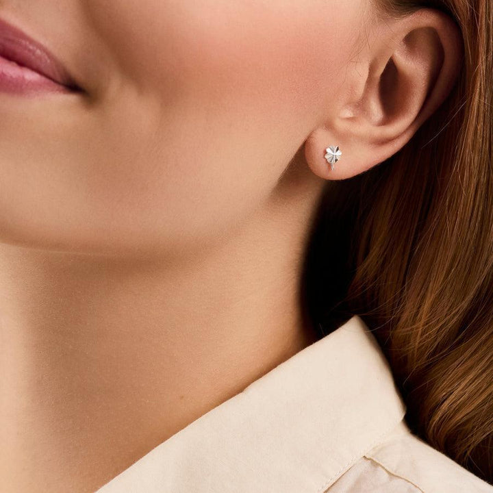 Pernille Corydon Clover Earrings shown on ear, silver color and simple style. Model E-320-S.