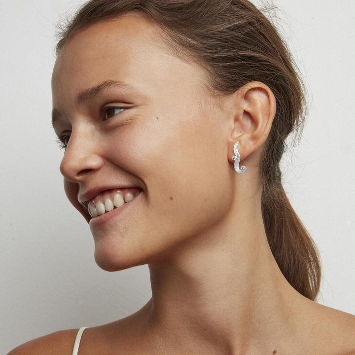 Polar Jewelry The Darning Needle silver ear ring worn by model, shown from the side. Model st-l-sl-wz-00335-2.