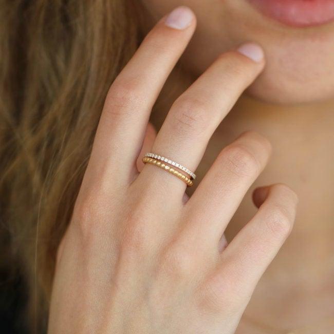 ro copenhagen 18kt orbit dot ring worn on woman's hand, elegant and in gold with discreet details, Model90878-001-2